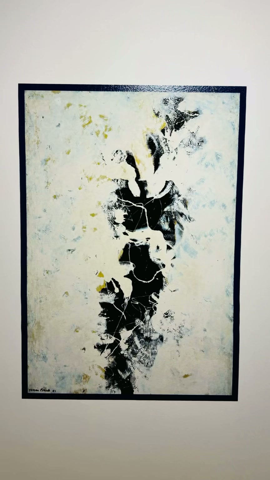 Large monochrome artwork with a printed border on an office wall.