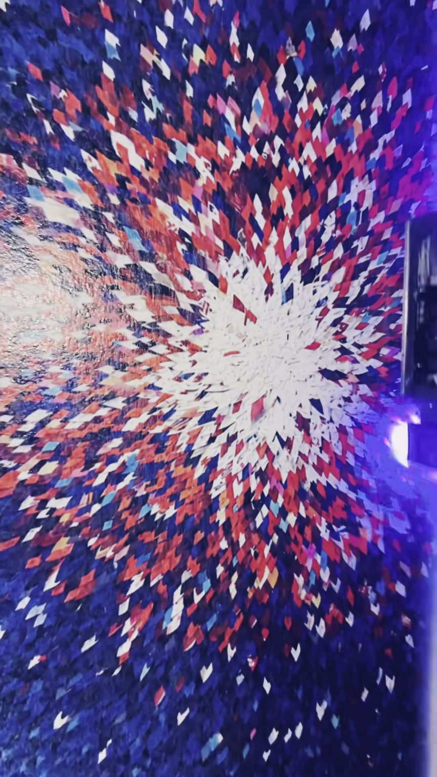 Wall-wide geometric composition in blue, red and white printed across an office surface.