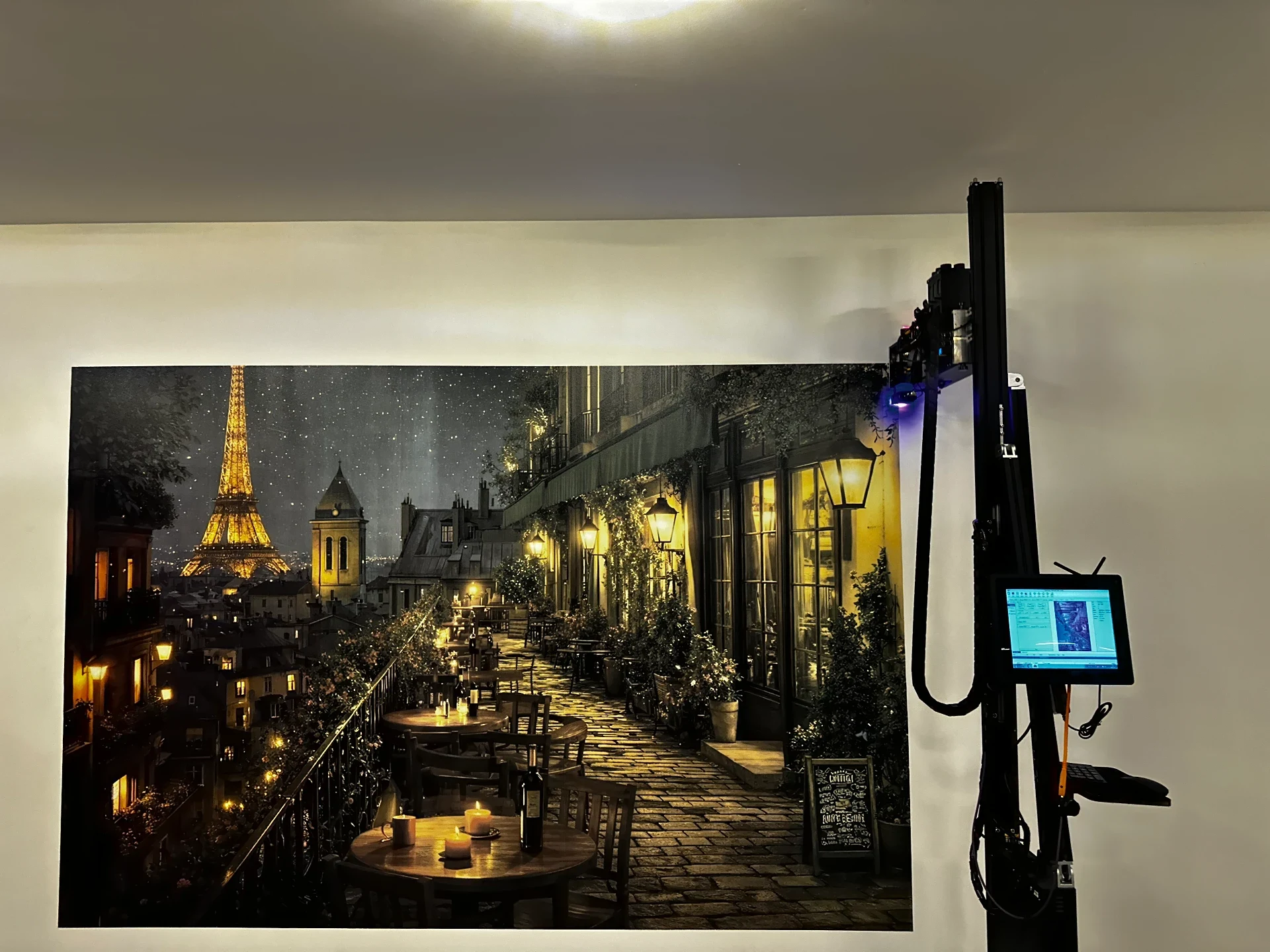 Paris scene printed on a wall beside the vertical wall-printing equipment.