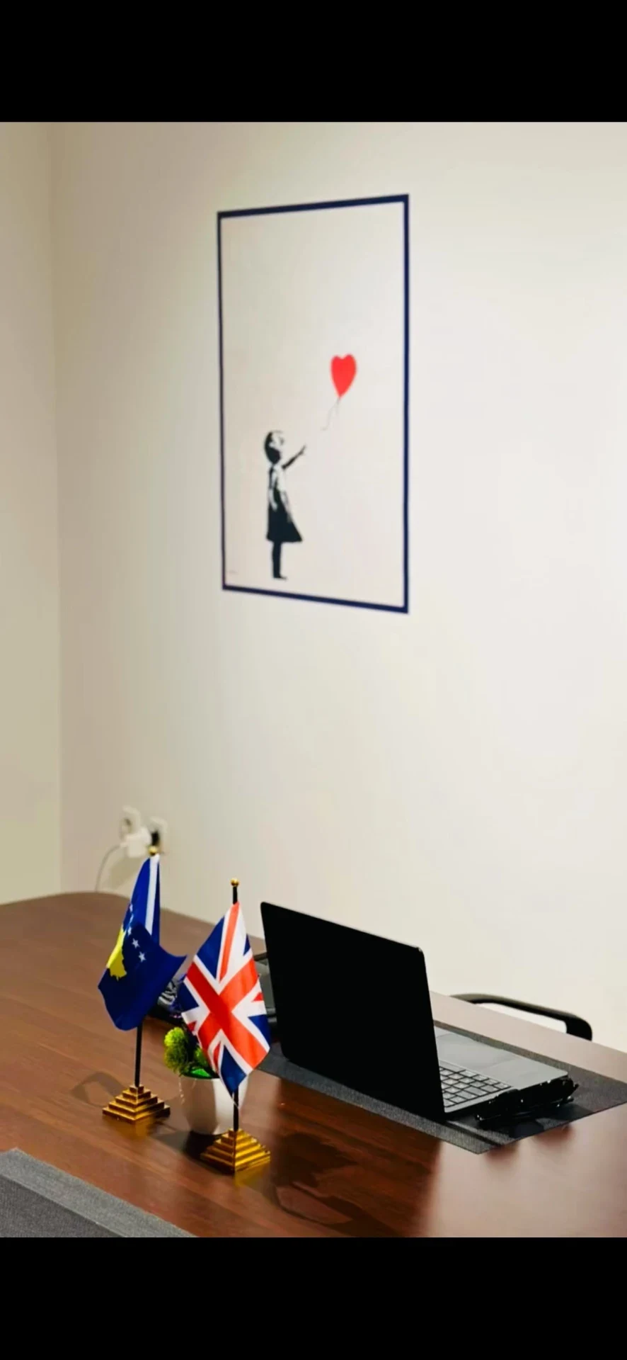 Girl and red-balloon artwork on the BlueIxia office wall.